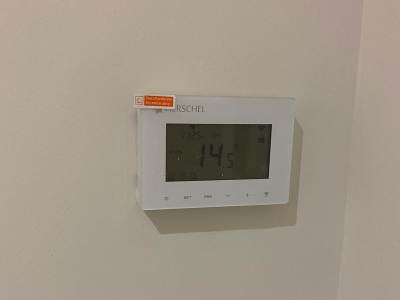 Electrician from AC Electricals (UK) Ltd fitting an infra-red panel in Kent