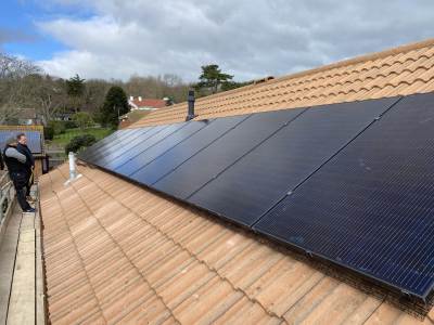 AC Electricals (UK) Ltd technician installing a solar inverter in Kent